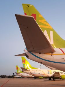 Aeronaves da frota da Modern Logistics estacionadas no aeroporto, mostrando suas caudas com o logotipo colorido da empresa.